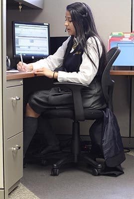 Cristo Rey Atlanta Jesuit High School freshman Bethy Ramirez-Sanchez works in her cubicle at Obstetrics and Gynecology of Atlanta. Ramirez-Sanchez works at the company five days a month. Photo By Michael Alexander