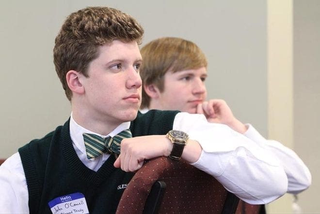 Blessed Trinity High School juniors John O’Connell, foreground, and Jack Arndt listen to the keynote speaker during the Catholic Relief Services Rice Bowl Kickoff for Catholic Schools at the Archdiocese of Atlanta Chancery, Feb. 13. The Blessed Trinity students who attended are involved in service projects and they are interested in starting a school-wide Rice Bowl project during Lent at the Roswell Catholic school. Photo By Michael Alexander