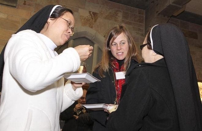 Dominican Sisters Mary Thu Cuc Ngo, left, and Maria Gertrude Tran Vun, right, chat with Mary Monette, a consecrated woman in Regnum Christi. Photo By Michael Alexander