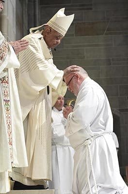 Archbishop Wilton D. Gregory lays hands upon diaconate candidate William Donohue of Prince of Peace Church, Flowery Branch. Photo By Michael Alexander