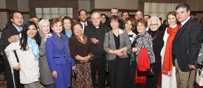 During the reception in the Cathedral of Christ the King’s Kenny Hall, Deacon Bernardo Buzeta, center, gathers for a photograph with his wife of 38 years, Aida, right center, and other relatives and friends. Deacon Buzeta will serve at his parish, Holy Cross Church, Atlanta. Photo By Michael Alexander