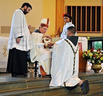 Bishop Gregory Hartmayer, OFM Conv., of the Diocese of Savannah, anoints the hands of Father Gabriel Scasino during the rite of ordination at St. Philip Benizi Church, Jonesboro. Photo By Lee Depkin