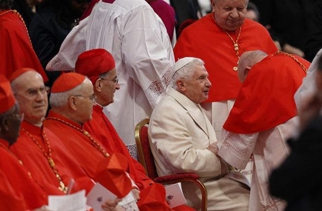 Retired Pope Benedict XVI greets a cardinal before a consistory at which Pope Francis created 20 new cardinals in St. Peter's Basilica at the Vatican Feb. 14. CNS photo/Paul Haring