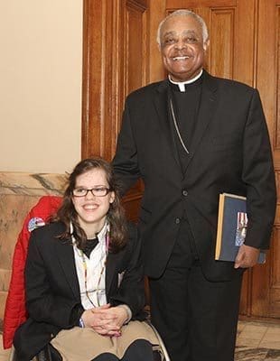 Noelle Ford, 15, gets her own photo with Archbishop Wilton D, Gregory during Catholic Day at the Capitol, Feb. 3. The Sophia Academy freshman accompanied seven of her fellow students and staff to the annual event. Photo By Michael Alexander