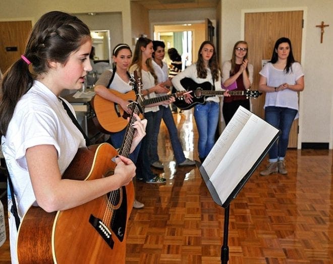 Grace Repasky, 14, performs for patients at Our Lady of Perpetual Help Home, Atlanta, while other members of TROTT watch in the background. Photo By Lee Depkin