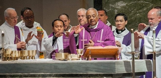 Archbishop Wilton D. Gregory is joined at the altar by priests of the archdiocese, who concelebrate the Recognition Day Mass and honor the women and youth of the year from their own parishes. This year’s Mass was celebrated Feb. 28. Photo by Thomas Spink