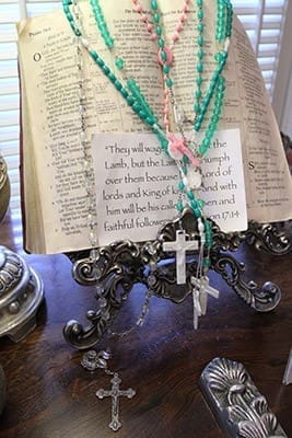 The Bible in the GraceWay chapel is open to the pages that show Psalm 79:1 through Psalm 81:3. Overlaying the pages are rosaries and a verse from Revelation 17:14, which falls under the heading, “Victory for the Lamb.” Photo By Michael Alexander