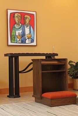 An area off to the side at Sts. Peter and Paul Church allows for prayer and the lighting of votive candles before a rendering of the Decatur parish’s patron saints. Photo By Michael Alexander