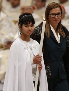Champa Maria Buceti from Cambodia holds a candle after being baptized by Pope Francis during the Easter Vigil in St. Peter's Basilica at the Vatican April 4.CNS photo/Paul Haring