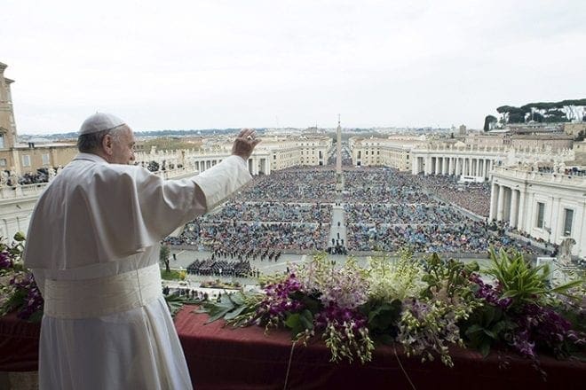 Pope Francis waves to the crowd during his Easter message and blessing "urbi et orbi" (to the city and the world) from the central balcony of St. Peter's Basilica at the Vatican April 5. CNS photo/L'Osservatore Romano via Reuters