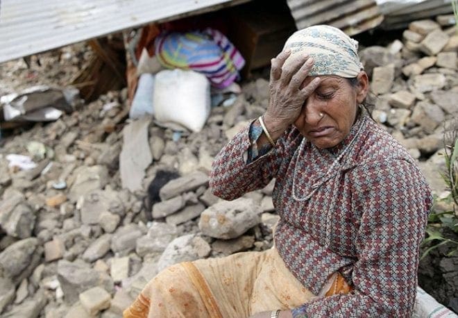 A woman mourns near the body of her 10-year-old daughter outside her destroyed home April 27 on the outskirts of Kathmandu, Nepal. More than 4,300 people were known to have been killed and an estimated 1 million people were left homeless after a magnitude-7.8 earthquake hit a mountainous region near Kathmandu April 25. .