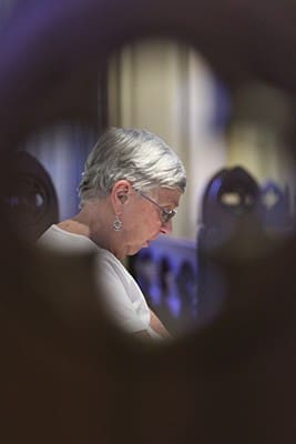 Margaret Stevenson prays in silence as she and others at Our Lady of the Assumption Church, Atlanta, meditate on seven selective mysteries of the rosary that represent God’s love for us. Photo By Michael Alexander