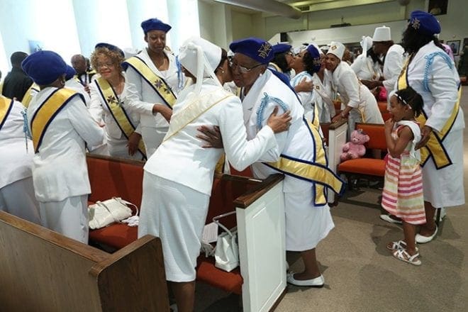 As the congregation greeted one another with a sign of peace, so did members of the Knights of Peter Claver Ladies Auxiliary at Sts. Peter and Paul Church, Decatur. They came together during a liturgy that coincided with Council and Court 313’s 25th anniversary. Photo By Michael Alexander