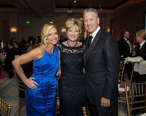 Jill Becker, center, was honored May 16 at the Believe Ball to benefit CURE Childhood Cancer. Tom and Chris Glavine, who were honored in 2014, were among the hosts of the 2015 ball. Becker, whose son survived childhood cancer, has worked with CURE for over 20 years. Photo By Lynn Crow