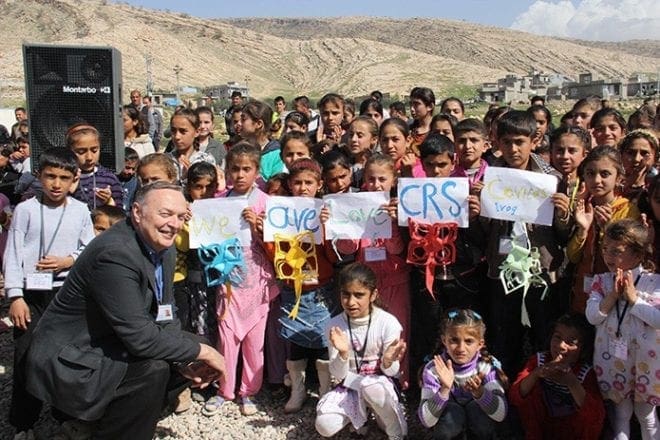 Children from internally displaced families in Iraq celebrate the opening of a new child-friendly space in northern Iraq with Cullen Larson, front left, of Catholic Relief Services in Atlanta. Most of the displaced children are no longer attending school and Caritas and CRS are working to provide them informal educational activities in a safe environment. Photo By Catholic Relief Services