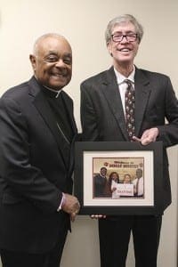 Patrick J. Mannelly, right, recently retired from the board of directors of GRACE Scholars, the student scholarship organization that raises money for Catholic schools in the Atlanta Archdiocese and the Diocese of Savannah. He stands with Atlanta Archbishop Wilton D. Gregory. Mannelly will be succeeded by Bob Fitzgerald. Photo by Michael Alexander
