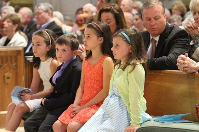 Some of Father Richard Morrow’s relatives were in attendance at his 60th jubilee Mass. They included some of his youngest cousins (front row, l-r) Ashley Stockdale of Darien, Conn., Michael McKenna of Ridgewood, N.J., Ashley’s sister Victoria, and Meredith McKenna of London, England. Immediately behind them are Mary Stockdale, left, the mother of Ashley and Victoria, and Mary’s brother Michael McKenna, the father of young Michael. Photo By Michael Alexander