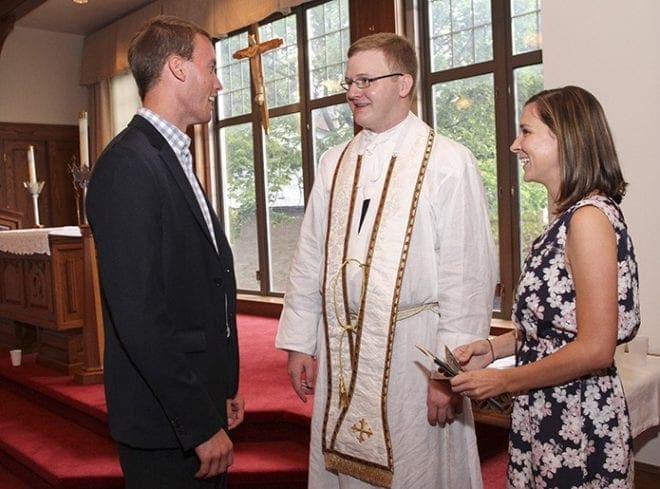 During the reception that followed the June 27 ordination, Father Timothy E. Nadolski, center, speaks with James and Sarah McNeil, parishioners at St. Catherine of Siena Church, Kennesaw. All three were members of the St. Pius X High School 2007 senior class. Photo By Michael Alexander