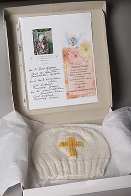 Ninety-two-year-old Ginny Burnett of Christ the Redeemer Church, Dawsonville, made a hat for Pope Francis. The pastor Father Brian Higgins, neighboring Good Shepherd Church pastor Father Frank Richardson and Good Shepherd parochial vicar Father Ignacio Morales blessed the hat. In the gift box with the hat, Burnett also included a photo of herself with a prayer of blessing for the pope. Photo By Michael Alexander