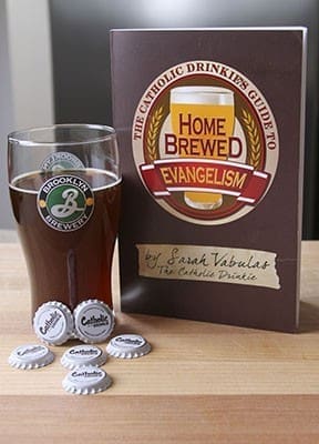 Sarah Vabulas’ new book, “The Catholic Drinkie’s Guide to Homebrewed Evangelism,” is displayed next to her home-brewed version of bourbon dubbel style beer. Half of the book is devoted to faith and evangelization and the other half teaches readers how to home brew. Photo By Michael Alexander