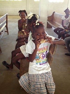 Children eat marshmallow treats made from Rice Krispies at the birthday party for all the children organized by St. Matthew Church mission team in January. The children had never tasted this treat before.