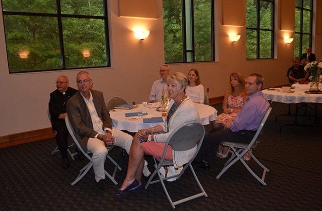 Bishop David P. Talley, seated left, joins members of the community who are dedicated to including those with disabilities and their gifts into all aspects of life. Seated foreground are Kevin and Donna Carroll, of St. Thomas Aquinas Church, Alpharetta, who are working on a proposed living community for young adults. Photo By Cindy Connell Palmer