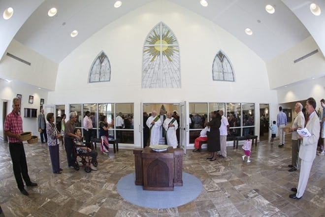 Deacon Jerry Connell, left, retired, and Deacon Tom Metzger of St. Anna Church lead the procession of clergy out of the sanctuary at the conclusion of the Mass of dedication. Photo By Michael Alexander