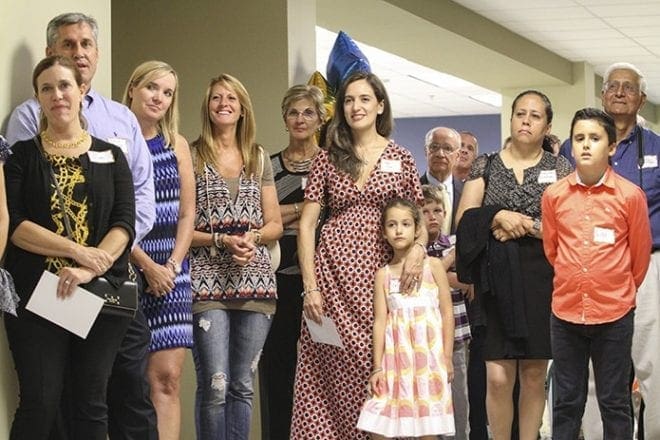 High school and middle school parents, friends and supporters of Notre Dame Academy attend the blessing, dedication and ribbon-cutting ceremony marking the opening of the new high school wing, Kavanaugh Hall, for the 2015-2016 school year. Photo By Michael Alexander