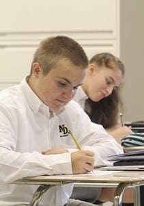 Just before an introductory icebreaker in their first class, Spencer Johnson, foreground, and Audrey Lesperance, background, jot down notes about some of their personal character traits. Photo By Michael Alexander