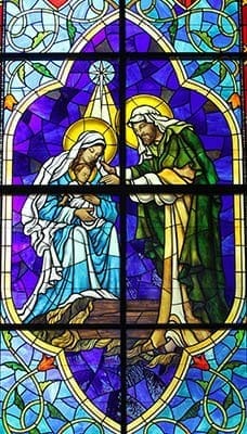 A stained glass window of the Nativity of Jesus prominently appears in the left transept of St. Michael the Archangel Church. The right transept contains a stained glass window of Pentecost, which means the facing windows depict the birth of the Church and the birth of the Lord. Photo By Michael Alexander