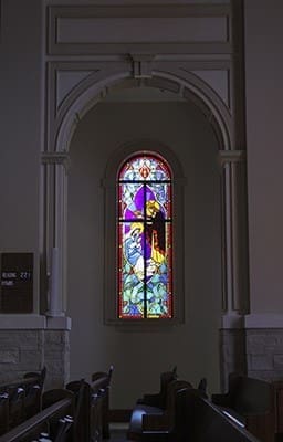 A stained glass window of the coronation of Mary, just to the right side of altar, was made in the memory of Mathew John Meyer, a parishioner who died in a motorcycle accident on his way to the March 2014 church groundbreaking. The stained glass windows that appear throughout the church represent the glorious, sorrowful, luminous and joyful mysteries of the rosary. Photo By Michael Alexander
