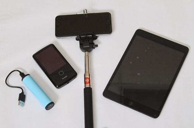 The portable equipment Rosemary Jean-Louis will take with her includes (l-r) a charger, a video recorder, a smartphone and selfie stick, and a digital tablet. Photo By Michael Alexander