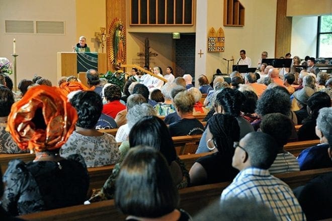 Father James McCurry, OFM Conv., shares his homily before a packed congregation during the jubilee anniversary Mass at St. Philip Benizi. Photo By Lee Depkin