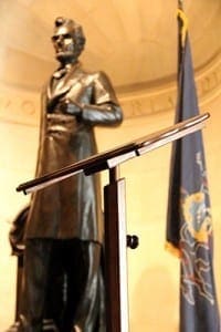 The lectern that President Abraham Lincoln used to deliver the Gettysburg Address almost 152 years ago is seen Aug. 7 at the Union League of Philadelphia in front of a statue of Lincoln. Pope Francis will use same lectern when he speaks at Independence Hall Sept. 26 during his two-day visit to Philadelphia this fall. CNS photo/Sarah Webb, CatholicPhilly.com 