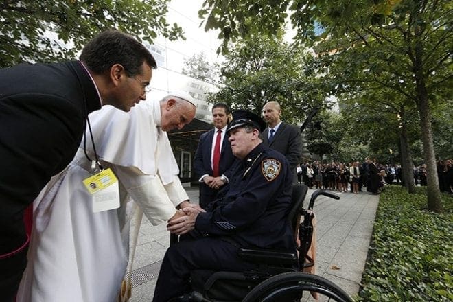 Pope Francis greets a New York City police officer as he visits the ground zero 9/11 Memorial in New York Sept. 25. CNS Photo/Paul Haring
