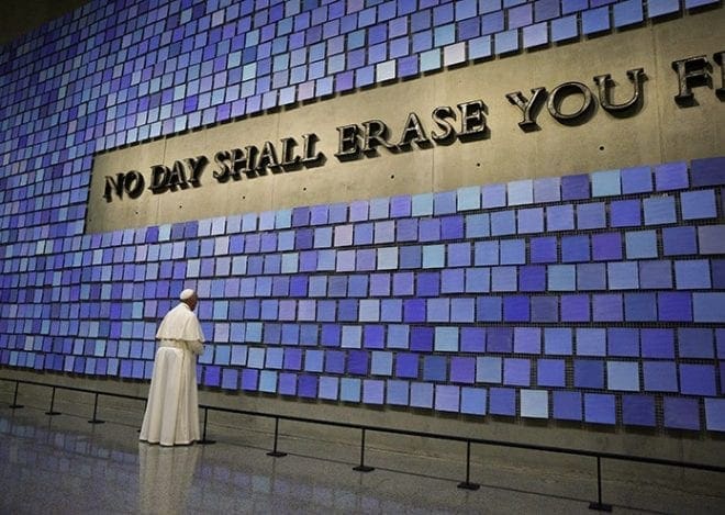 Pope Francis pauses in front of a display at the National 9/11 Memorial and Museum in New York Sept. 25. The Virgil quotation on the wall reads, "No day shall erase you from the memory of time." CNS Photo/Paul Haring