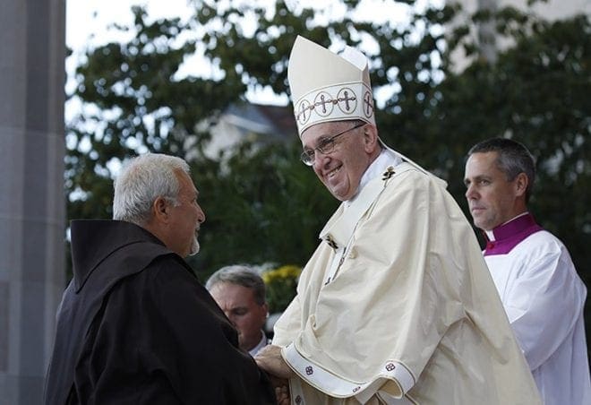 Pope Francis greets a Franciscan as he celebrates Mass and the canonization of Junipero Serra outside the Basilica of the National Shrine of the Immaculate Conception in Washington Sept. 23. CNS Photo/Paul Haring 