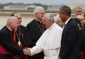 President Barack Obama walks beside Pope Francis as he greets dignitaries upon his arrival at Joint Base Andrews in Maryland just outside of Washington Sept. 22. 