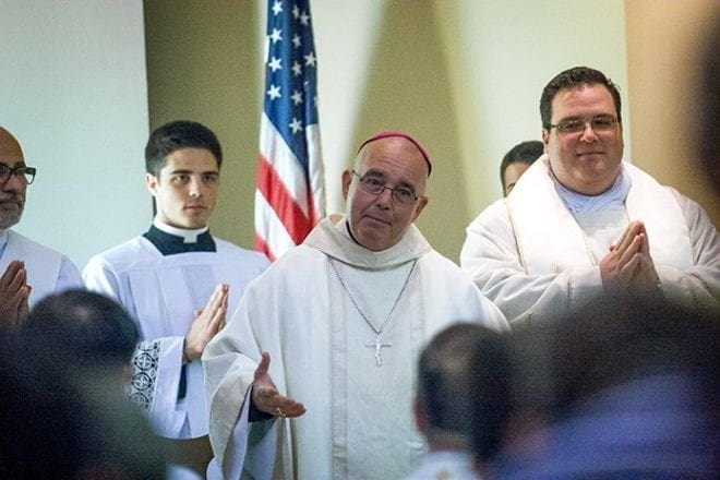 Bishop David P. Talley, center, was the main celebrant for the anniversary Mass. Father Josh Allen, right, chaplain, was the homilist, offering encouragement to parents, “God knows what he is doing.” The Georgia Tech Catholic Center offers prayer, instruction, social events, Bible studies and a quiet place to hang out. Photo By Thomas Spink