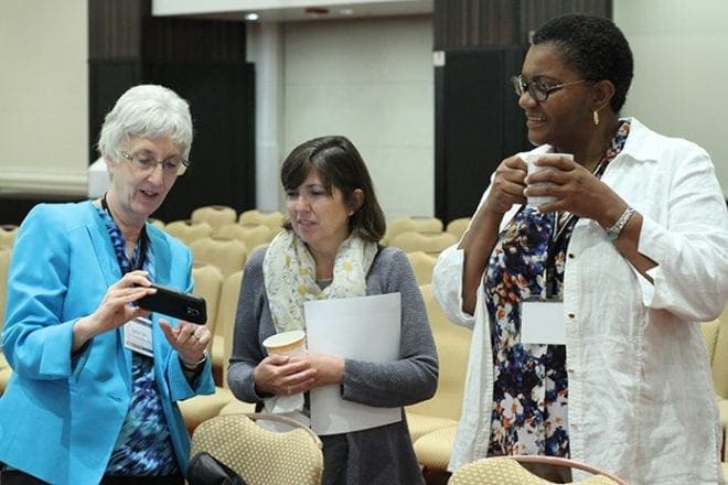 (L-r) Laura Clark, chief financial officer for the Diocese of San Bernardino in California, Bobbi Hanningan, manager of diocesan initiatives for Catholic Extension in Chicago, and Ursula Hinkson, associate director of financial affairs for the Diocese of San Bernardino, converse over a break between general sessions during the annual meeting of the Diocesan Fiscal Management Conference at the Hyatt Regency Atlanta hotel. Photo By Michael Alexander