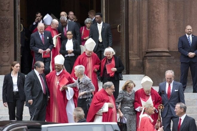 (Foreground, third from left) Archbishop Wilton D. Gregory talks to Supreme Court Justice Antonin G. Scalia (second from left) following the annual Red Mass at the Cathedral of St. Matthew the Apostle in Washington Oct. 4. The Mass traditionally marks the start of the court year, including the opening of the Supreme Court term. Photo By Jaclyn Lippelmann/Catholic Standard 
