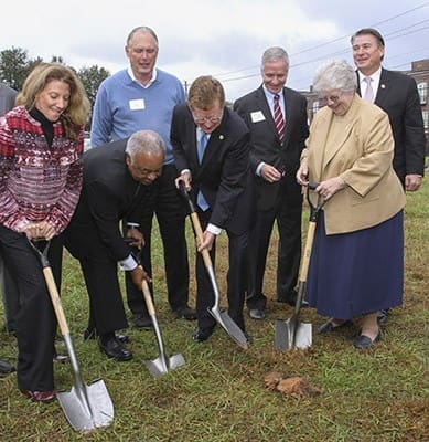 (Back row, l-r) Don Brooks, chair of the Saint Joseph's Health System, Tom Andrews, president of Mercy Care, and Eric Clarkson, mayor of Chamblee, look on as (foreground, l-r) Kim Marchner, chair of the Mercy Care board, Archbishop Wilton D. Gregory, Dave Fitzgerald, co-chair of the Mercy Care Chamblee Capital Campaign, and Sister of Mercy Angela Ebberwein, vice president, mission, Mercy Care, take their roles seriously as they dig into the wet and soggy ground during the ceremonial groundbreaking. The new 45,000-square-foot clinic facility is scheduled for a spring 2017 opening in Chamblee. Photo By Michael Alexander