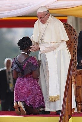 Pope Francis embraces Winnie Nansumba, who was born with and is living with HIV, during a meeting with young people at the Kololo airstrip in Kampala, Uganda, Nov. 28. Nansumba, 24, is involved in advocating for other people living with HIV/AIDS and in the fight against the spread of the disease. CNS photo/Paul Haring