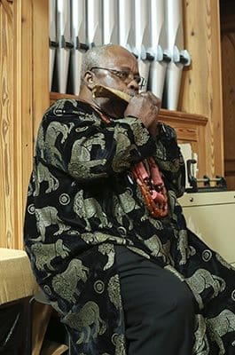 Dr. Ifeanyi J. Anikpe of St. Paul of the Cross Church, Atlanta, blows the horn during the Call to Worship. Photo By Michael Alexander