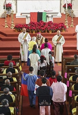 Archbishop Wilton D. Gregory receives the offertory gifts at the annual MLK Eucharistic Celebration Jan. 16. Members of the Haitian, Korean, Mexican and Peruvian community participated in the offertory procession. Photo By Michael Alexander