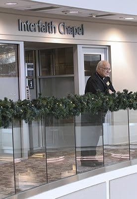 Deacon Whitney Robichaux, stands outside Interfaith Chapel in the domestic terminal atrium on the third floor of Hartsfield-Jackson Atlanta International Airport. Deacon Robichaux, one of 10 Catholic deacons who serve in the Airport Chaplaincy Program, works at the airport on Tuesdays and Thursdays, early morning to mid-afternoon. Photo By Michael Alexander