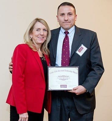 Cindy Nofi, left, stands with Xavier Balderas, winner of the Cindy Nofi Servant Leadership Award, at the Jan. 14 graduation ceremony for the 2015 Catholic Charities Atlanta Leadership Class. The award recognizes the class member who possesses a deep spirituality, is dedicated to helping others and has a true commitment to the program. Photo By Allison Shirreffs