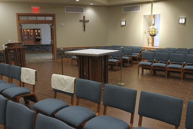 When the new day chapel at Prince of Peace Church, Flowery Branch, is not being used for perpetual adoration, it can serve as a surplus seating area during special and Sunday liturgies. The tabernacle was displayed to the right of the altar in the main sanctuary before the church renovation. Photo By Michael Alexander