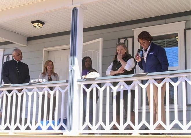 (Right to left) Lisa Y. Gordon, president and CEO of Atlanta Habitat for Humanity, shares some remarks from the front porch of the home during the Jan. 30 dedication as Dana Halberg, Atlanta Habitat for Humanity board member, Kiaira Dotson, the homeowner, Heather Dexter, CEO of Emory Saint Joseph's Hospital, and Archbishop Wilton D. Gregory look on. Photo By Michael Alexander