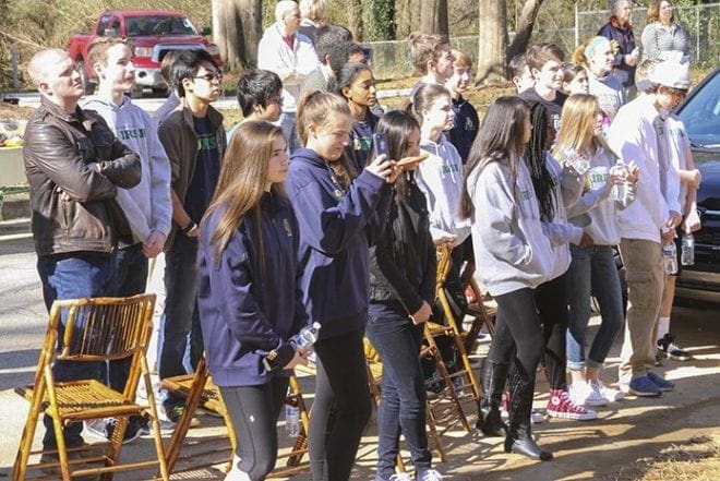 Freshman students from Notre Dame Academy High School, Duluth, and teacher John Henry Spann, back row, left, attend the Jan. 30 Atlanta Habitat home dedication in honor of Pope Francis. They also came the first weekend of the build and provided lunch for the volunteers. Photo By Michael Alexander